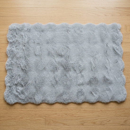 Soft rectangular floor mat in gray for home interiors