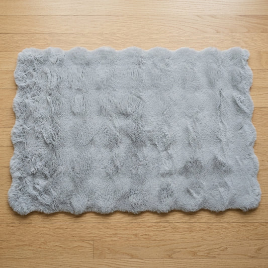 Soft rectangular floor mat in gray for home interiors