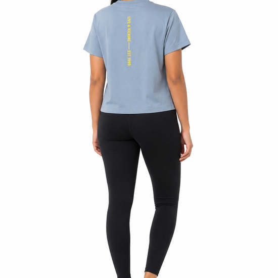 Back view of women's blue graphic T-shirt with printed detail