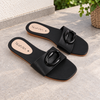 Nuvaara women's black flat slide sandals with glossy oval buckle accent and square toe