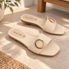 Nuvaara women's black faux leather flat slide sandals with polished gold circular ring buckle