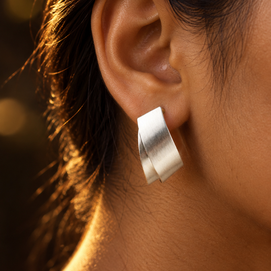 NUVAARA brushed silver-tone twisted ribbon huggie hoop earrings