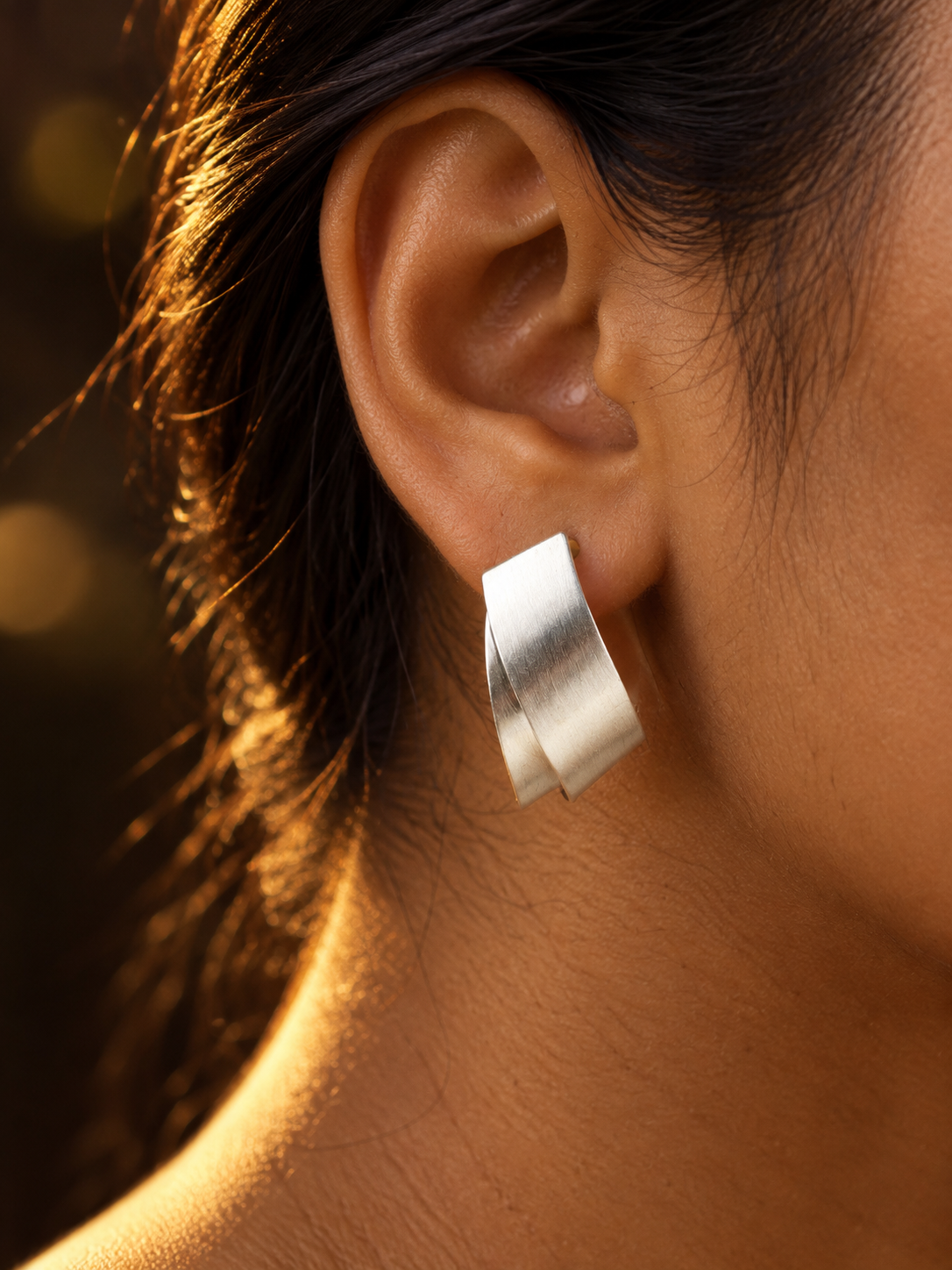 NUVAARA brushed silver-tone twisted ribbon huggie hoop earrings