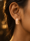 NUVAARA pink marbled resin curved huggie hoop earrings with gold-tone rim