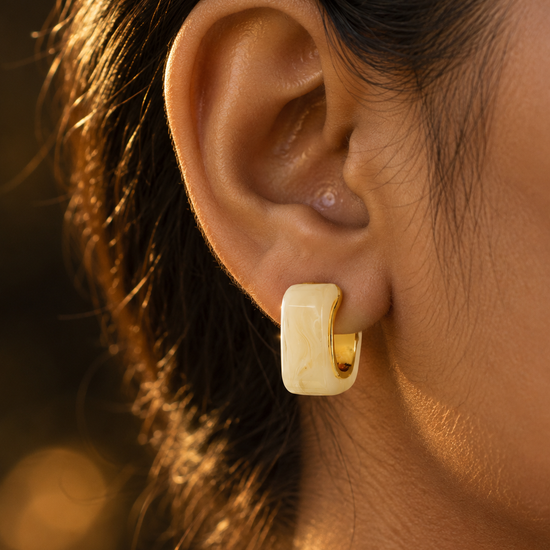 NUVAARA white swirl resin curved huggie hoop earrings with gold-tone rim
