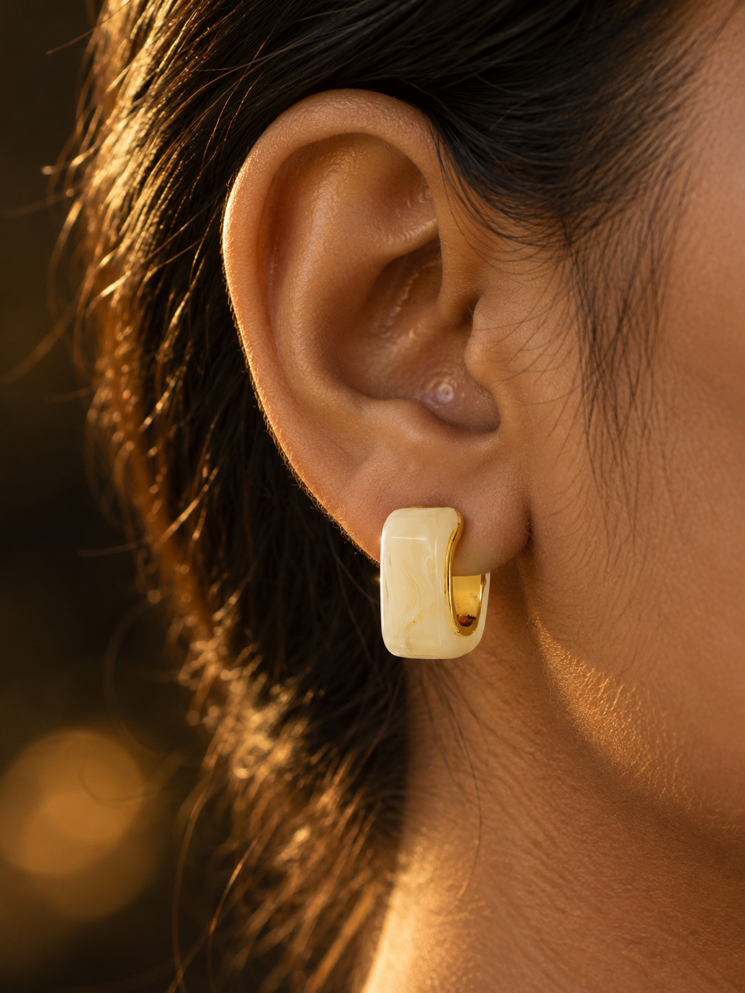 NUVAARA white swirl resin curved huggie hoop earrings with gold-tone rim