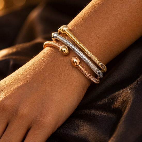 NUVAARA tri-color coiled cable wire open cuff bangles with ball finials on wrist
