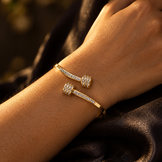 NUVAARA gold-tone pavé crystal barbell bypass cuff bracelet on wrist