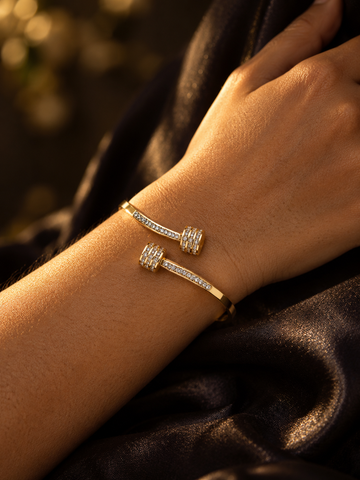 NUVAARA gold-tone pavé crystal barbell bypass cuff bracelet on wrist