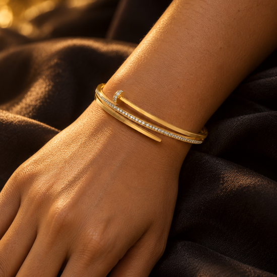 NUVAARA gold-tone pavé crystal nail motif bypass bangle bracelet on wrist
