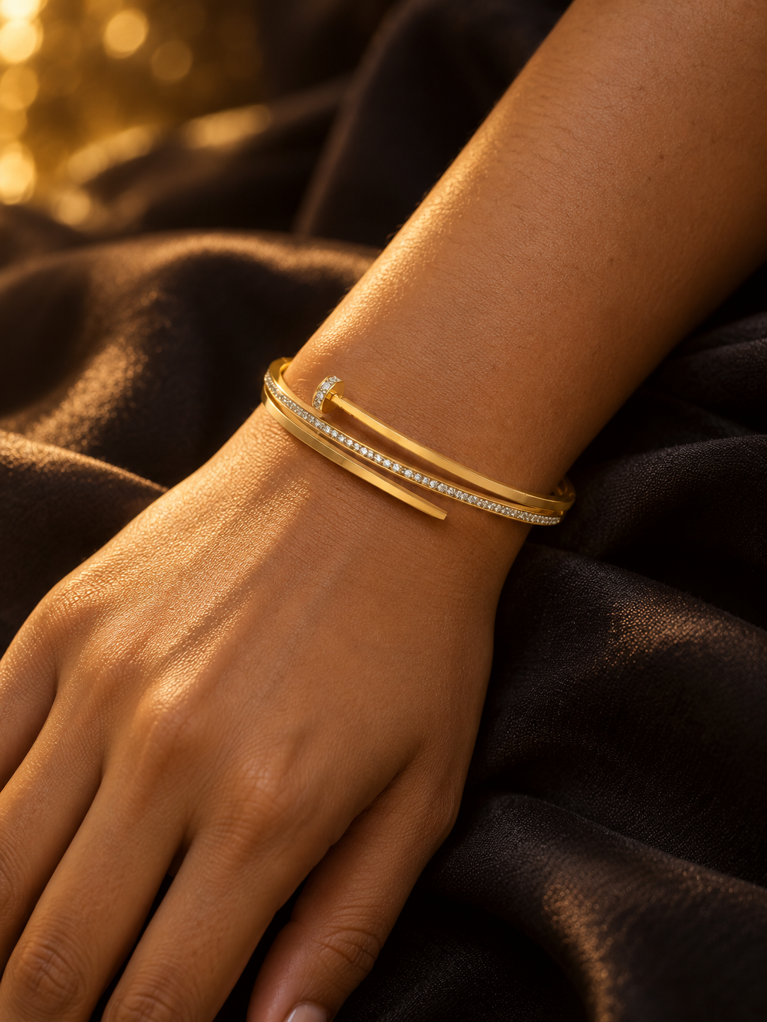 NUVAARA gold-tone pavé crystal nail motif bypass bangle bracelet on wrist