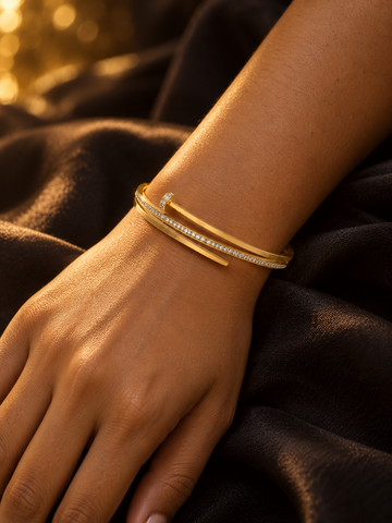 NUVAARA gold-tone pavé crystal nail motif bypass bangle bracelet on wrist