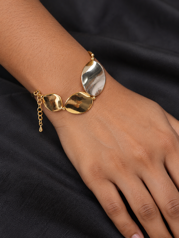 NUVAARA sculptural molten petal two-tone gold and silver link bracelet on model wrist