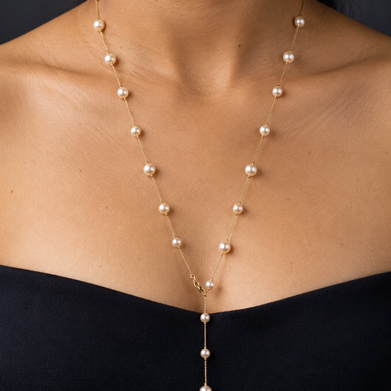 NUVAARA gold chain and faux pearl station Y-drop lariat necklace on model