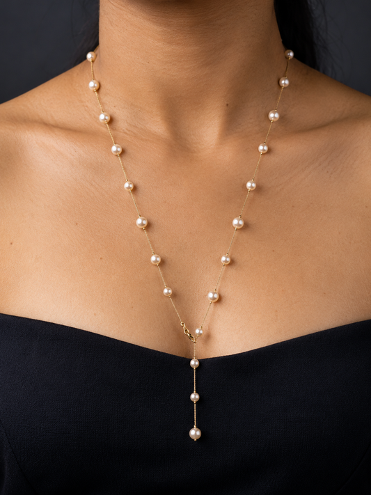NUVAARA gold chain and faux pearl station Y-drop lariat necklace on model