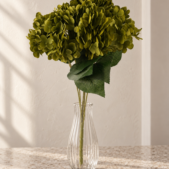 T&CO luxury artificial olive green hydrangea stem 68cm displayed in glass cylinder vase