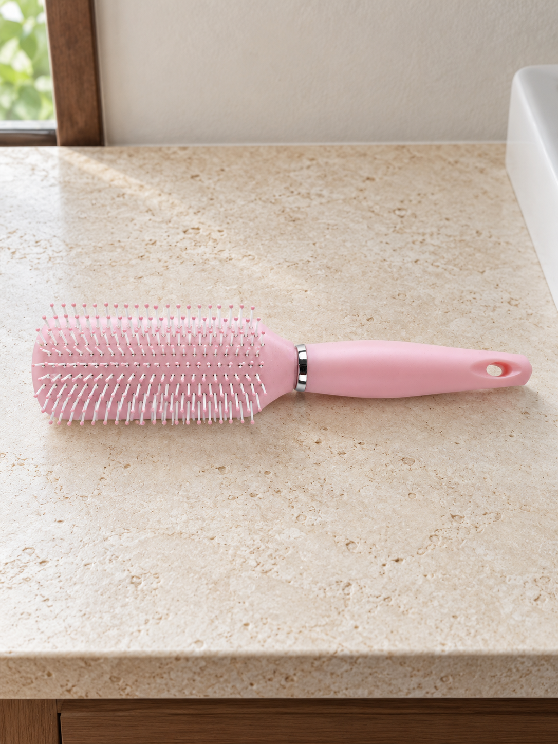 T&CO ergonomic cushioned detangling paddle hair brush with ball-tipped nylon bristles in pastel baby pink