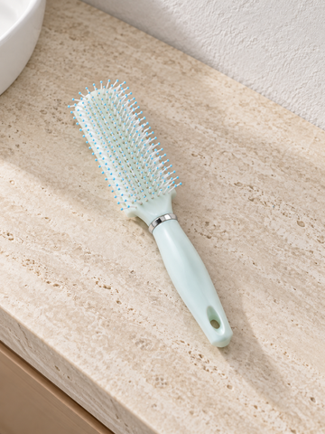 T&CO ergonomic cushioned detangling paddle hair brush with ball-tipped nylon bristles in pastel mint green