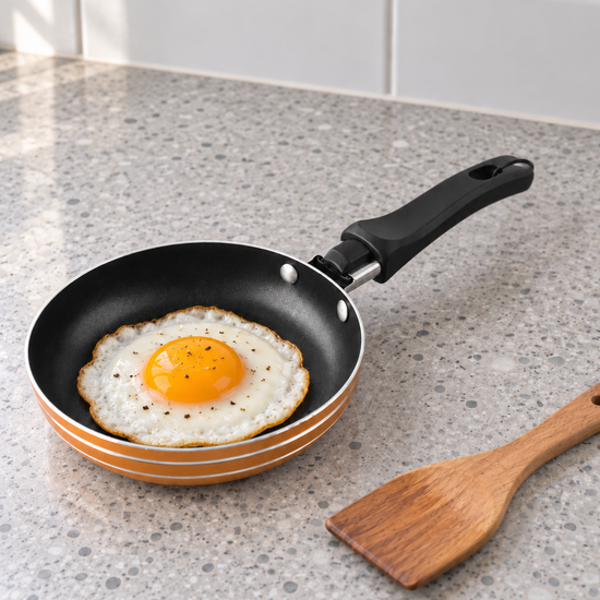T&CO mini non-stick 12cm single egg and pancake frying pan skillet in warm metallic orange with mini wooden spatula