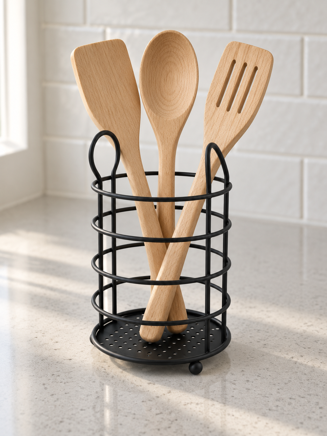 T&CO round wire countertop kitchen utensil holder caddy in matte black holding wooden spoons and cooking spatulas
