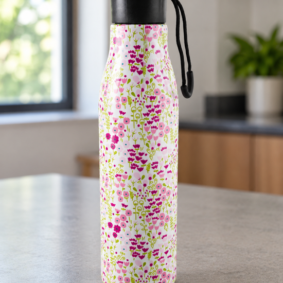 T&CO insulated stainless steel water bottle featuring delicate pink cherry blossom floral pattern on soft white background with carry loop