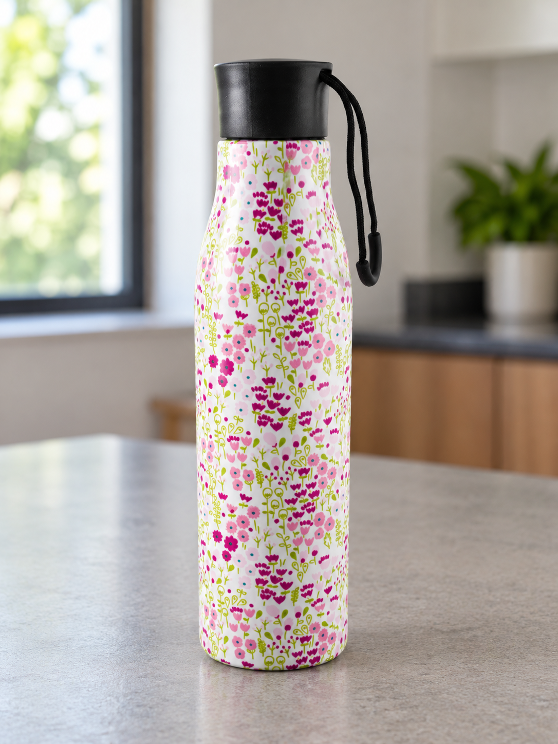 T&CO insulated stainless steel water bottle featuring delicate pink cherry blossom floral pattern on soft white background with carry loop