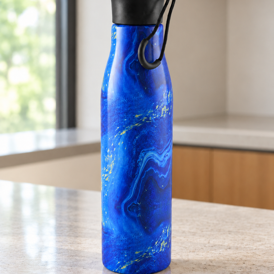 T&CO insulated stainless steel water bottle with vibrant ocean blue marble swirls and gold vein accents with carry loop cap