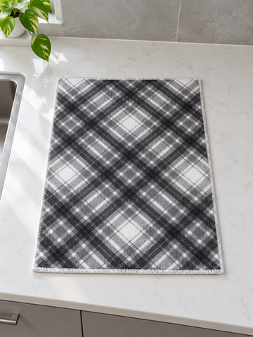 Fresh ultra-absorbent grey and white diagonal plaid microfiber dish drying mat with reinforced stitched border on countertop