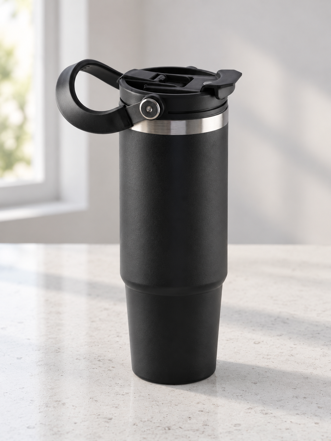 T&CO sleek matte black vacuum insulated travel tumbler with hinged top carry handle, stainless rim, and tapered base