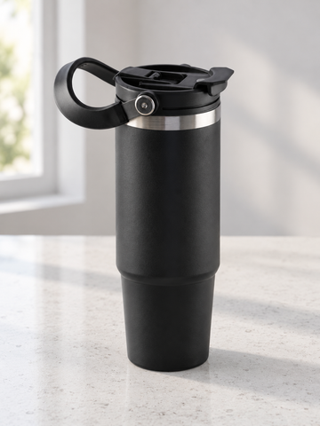T&CO sleek matte black vacuum insulated travel tumbler with hinged top carry handle, stainless rim, and tapered base