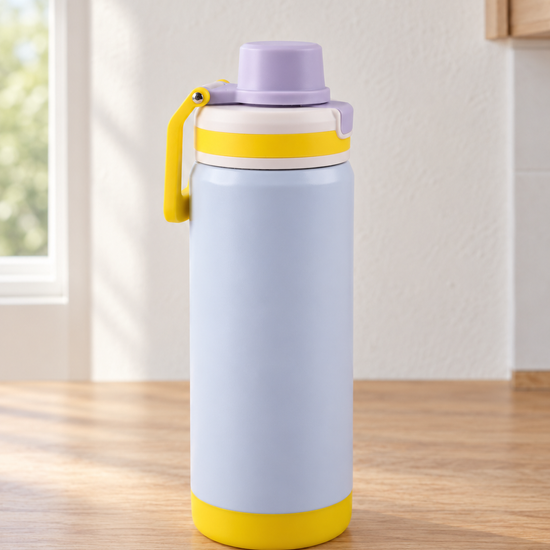 T&CO colorblock insulated sports bottle in pastel baby blue with vibrant yellow protective base and folding carry handle