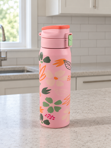 T&CO coral pink vacuum insulated flask featuring botanical floral petal motif with push-button flip lid and safety lock
