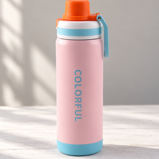 T&CO Colorful insulated sports bottle in baby pink with sky blue trim, orange spout cap, and folding carry handle