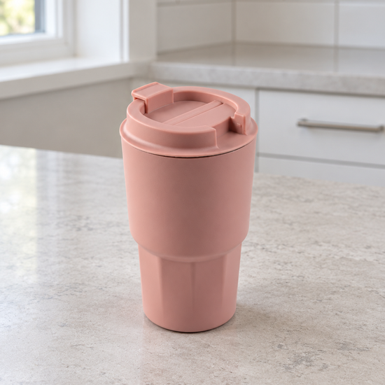T&CO dusty rose pink insulated coffee travel tumbler with faceted geometric lower base and flip-top sipping lid