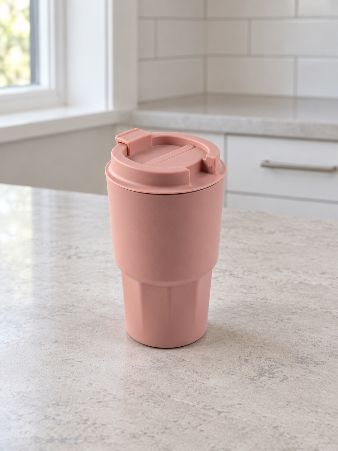 T&CO dusty rose pink insulated coffee travel tumbler with faceted geometric lower base and flip-top sipping lid