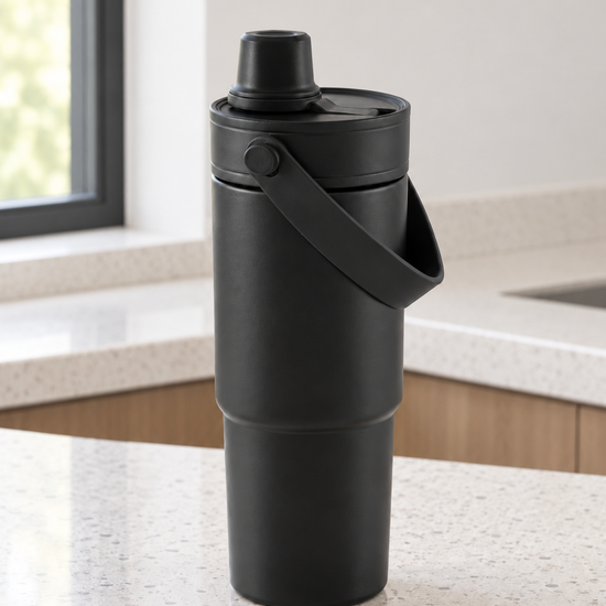 T&CO all-black matte insulated travel tumbler with folding swing carry handle and dual-function sipping spout lid
