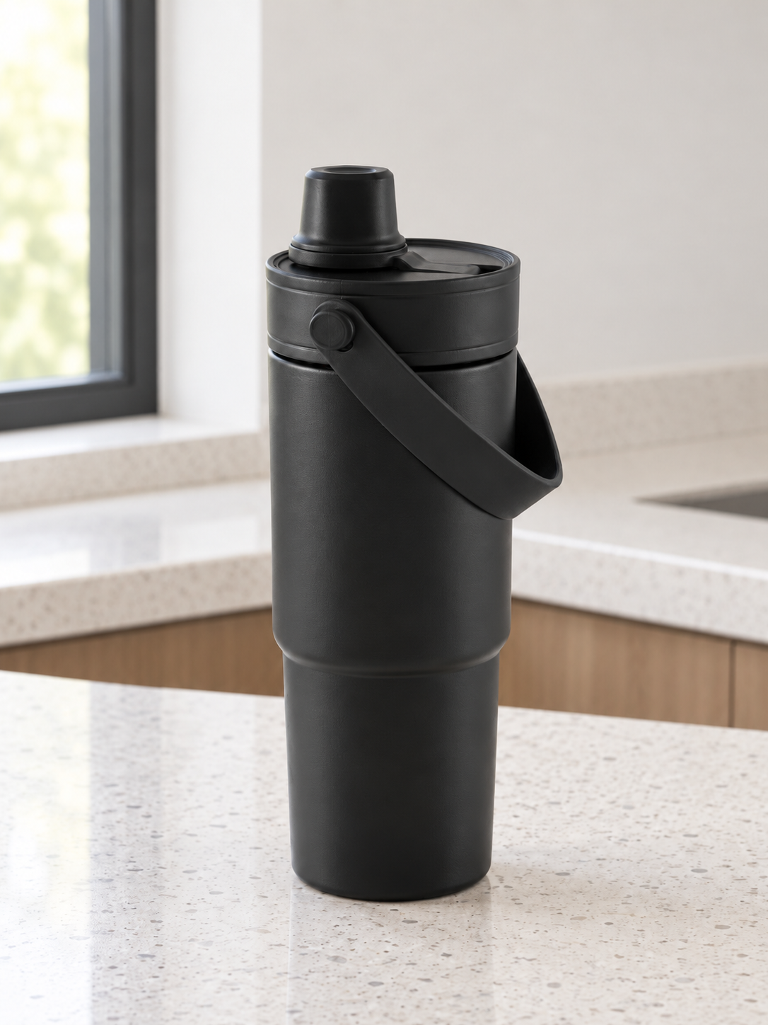 T&CO all-black matte insulated travel tumbler with folding swing carry handle and dual-function sipping spout lid