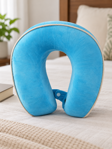 T&CO vibrant cyan blue ergonomic contoured memory foam travel neck pillow with white edge piping trim and snap closure strap