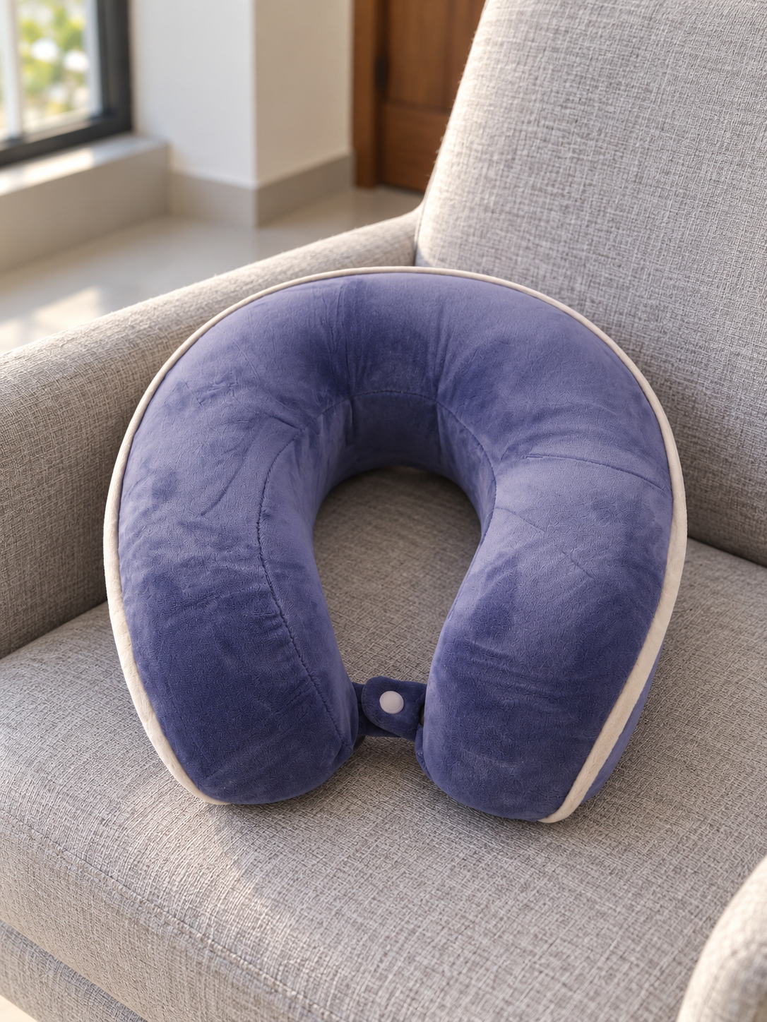T&CO lavender purple contoured memory foam travel neck pillow with white edge piping and snap strap closure