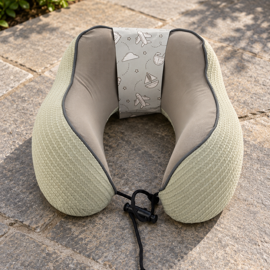 T&CO sage green waffle-knit memory foam neck pillow with taupe interior lining and adjustable toggle drawstring