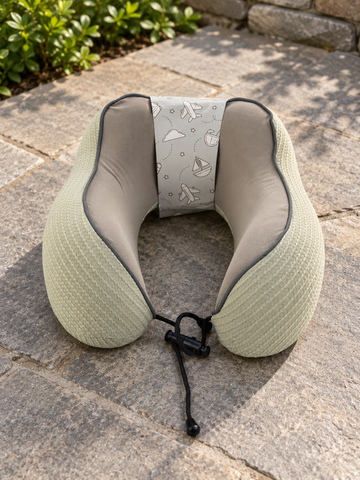 T&CO sage green waffle-knit memory foam neck pillow with taupe interior lining and adjustable toggle drawstring