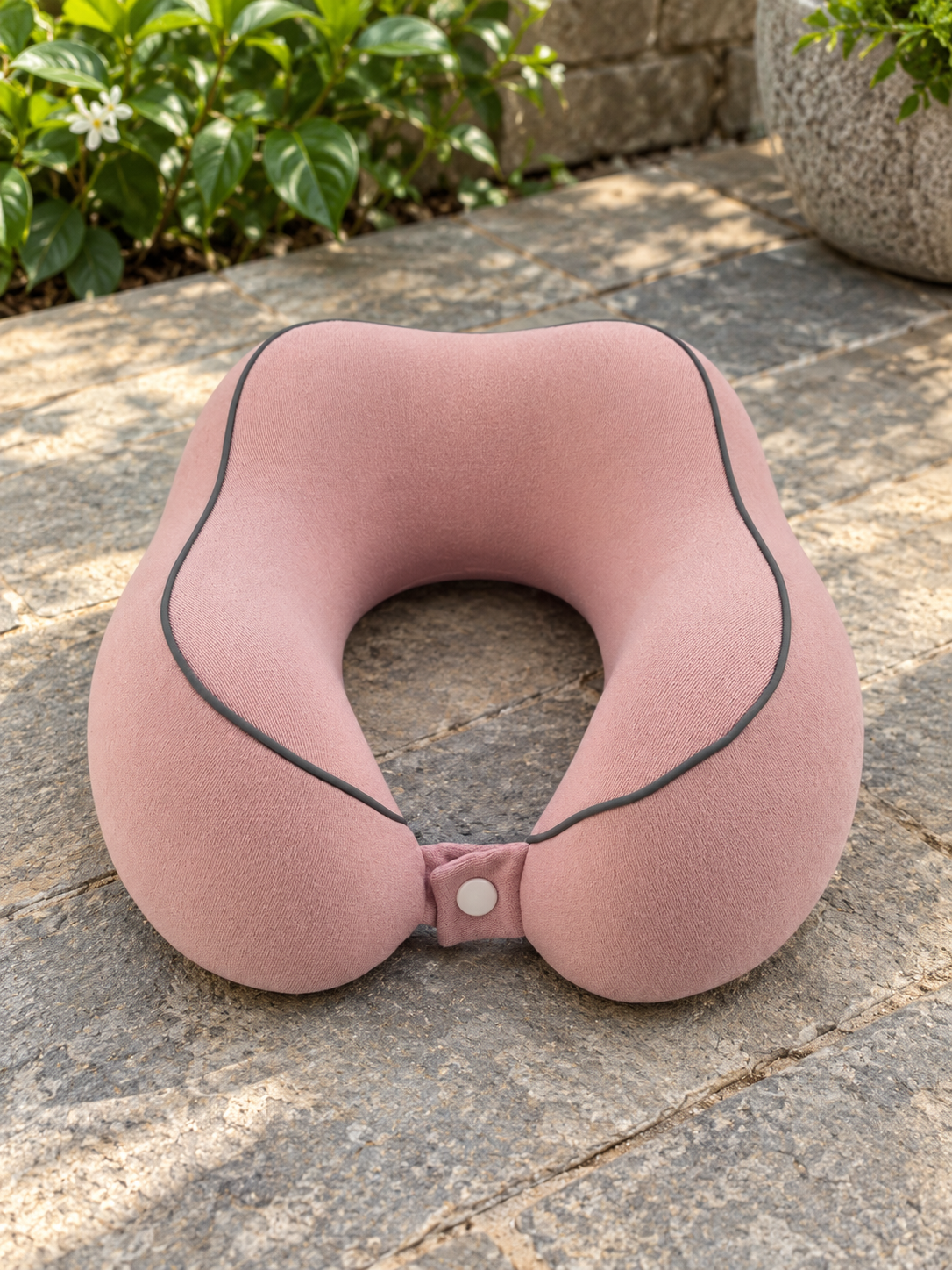 T&CO dusty pink contoured memory foam travel neck pillow with dark contrast piping and snap button strap