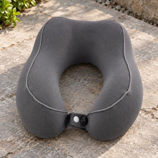 T&CO charcoal grey ergonomic contoured memory foam travel neck pillow with contrast piping and front snap button strap