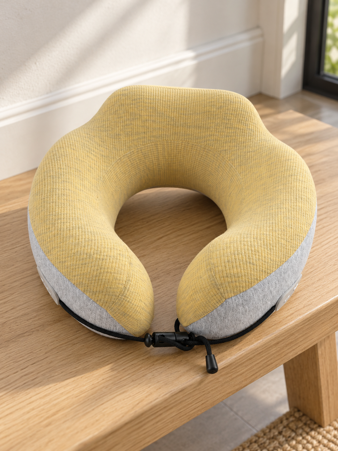 T&CO dual-tone ergonomic memory foam travel neck pillow in mustard yellow ribbed knit and heather grey with black toggle drawstring