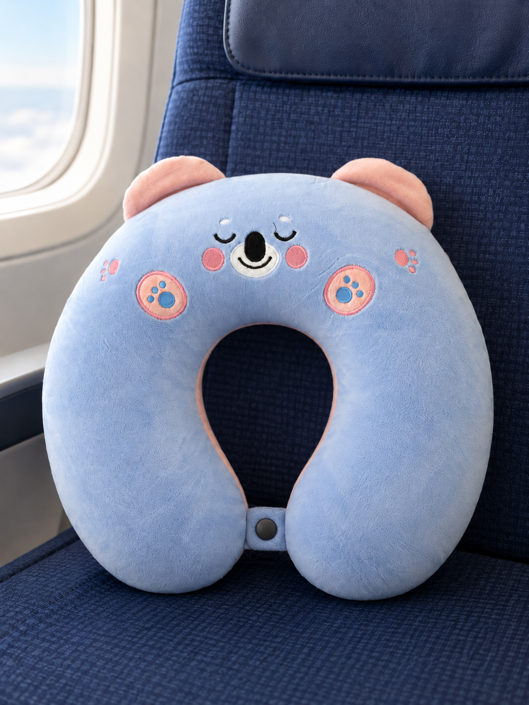 T&CO cute plush animal travel neck pillow in pastel baby blue koala bear design with pink inner ears and snap closure