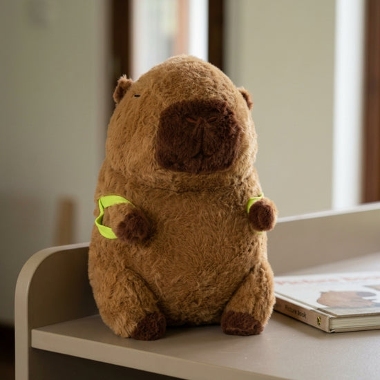 T&CO cute 24cm fluffy brown capybara plush stuffed toy with squinty sleeping eyes and neon green backpack shoulder straps