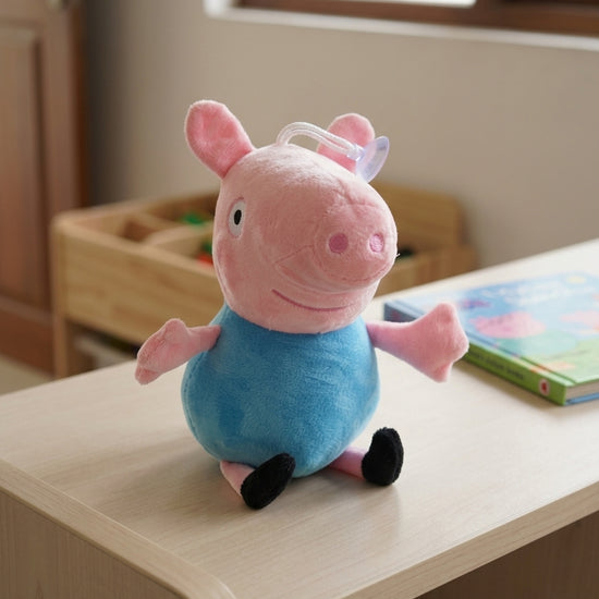 T&CO 19cm George Pig plush toy in baby blue shirt with round snout, outstretched arms, and window suction cup hanger