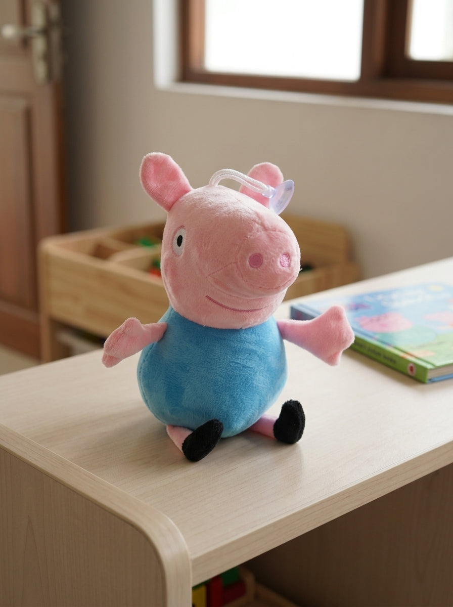 T&CO 19cm George Pig plush toy in baby blue shirt with round snout, outstretched arms, and window suction cup hanger