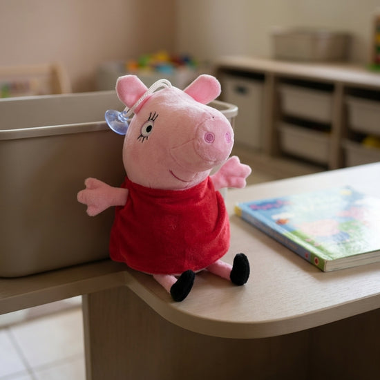 T&CO 19cm Peppa Pig plush toy in signature red dress with round snout, eyelashes, and window suction cup hanger