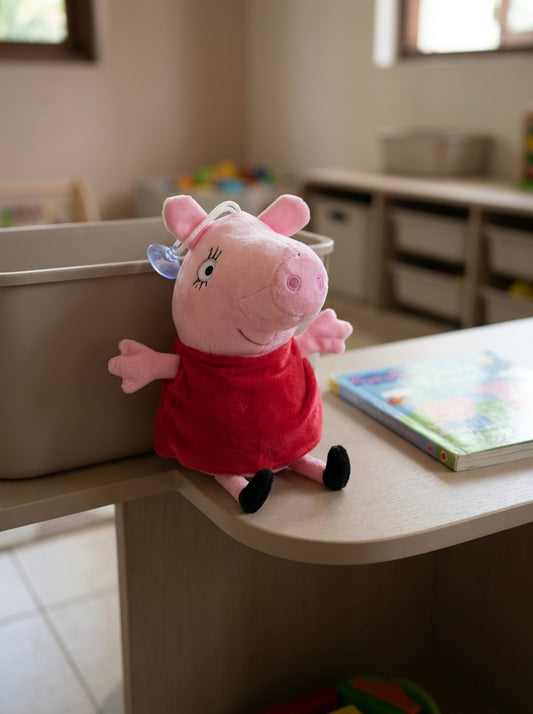 T&CO 19cm Peppa Pig plush toy in signature red dress with round snout, eyelashes, and window suction cup hanger